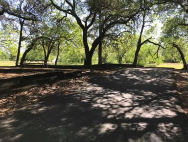 RV site with picnic table, grill, and fire ring