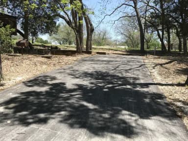 RV site with picnic table, grill, and fire ring