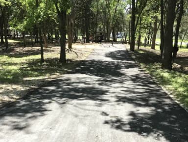 RV site with picnic table, grill, and fire ring