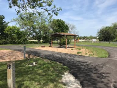 Pull through RV site with covered picnic table, grill, and fire ring