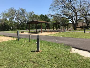 Pull through RV site with covered picnic table, grill, and fire ring