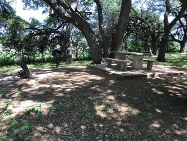 Tent site with picnic table, grill, and fire ring