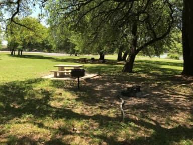 Tent site with picnic table, grill, and fire ring