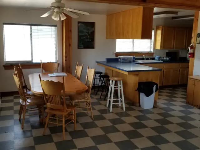 Inside of the Caretaker's cabin showing the kitchen and dining area with bar and table with 6 chairs