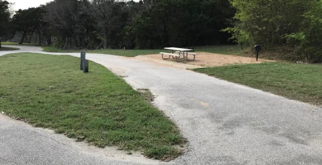Pull through RV site with grill, fire ring, and picnic table