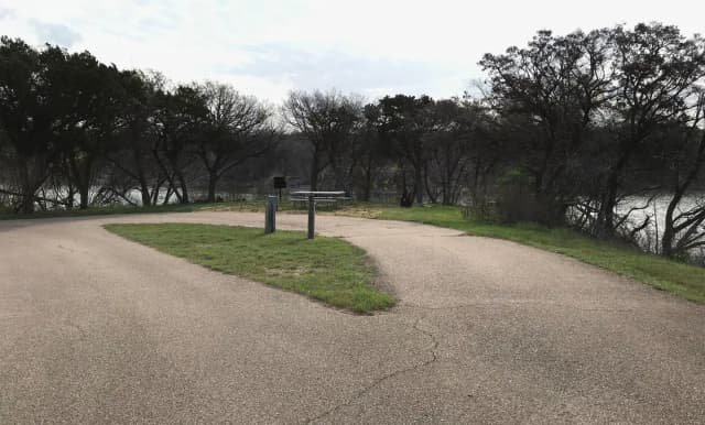 Pull through RV site with grill, fire ring, and picnic table
