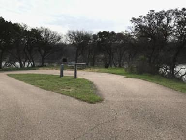 Pull through RV site with grill, fire ring, and picnic table