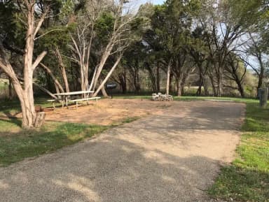RV site with picnic table, grill, and fire ring