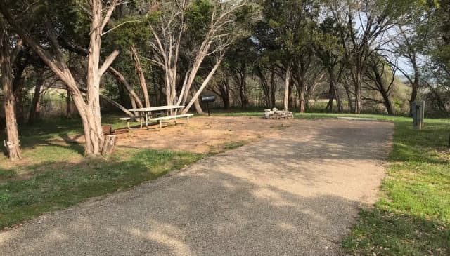 RV site with picnic table, grill, and fire ring