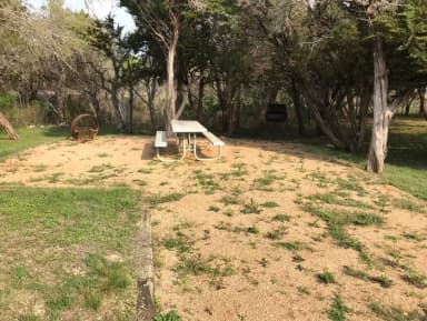 Picnic table, grill, and fire ring at site
