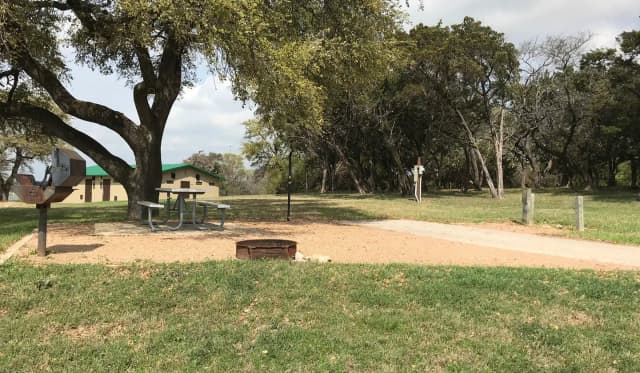RV site with picnic table, grill, fire ring, and restroom/shower facilities nearby