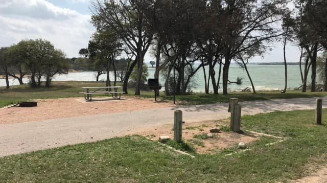 Pull through RV site with picnic table, grill, fire ring, and great view of Waco Lake
