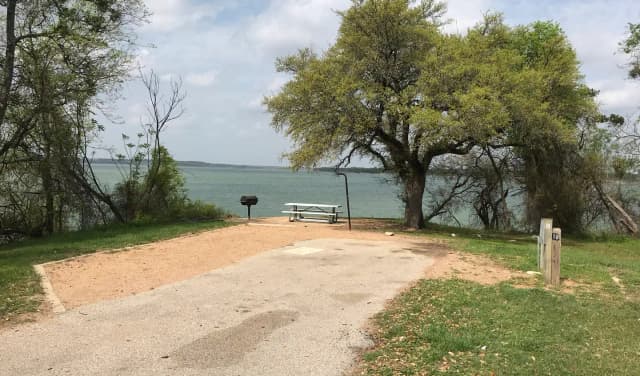 RV site with picnic table, grill, fire ring, and great view of Waco Lake