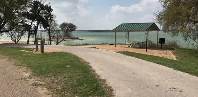 Pull through RV site with grill, fire ring, covered picnic table, and great view of Waco Lake