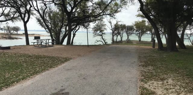 RV site with picnic table, grill, fire ring, and great view of Waco Lake