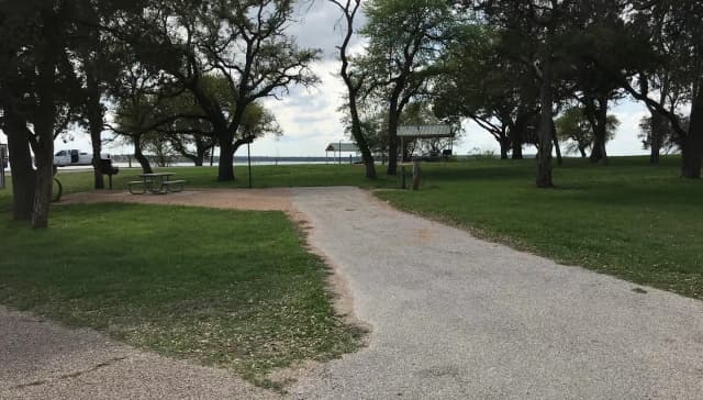RV site with picnic table, grill, and fire ring