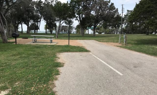 RV site with picnic table, grill, and fire ring