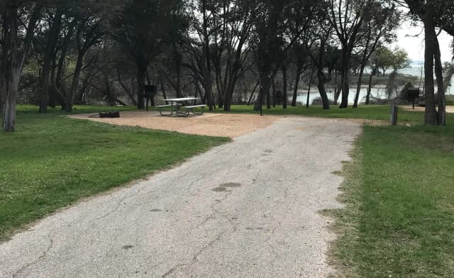 RV site with picnic table, grill, and fire ring
