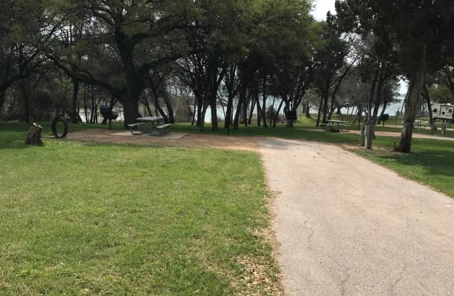 RV site with picnic table, grill, and fire ring