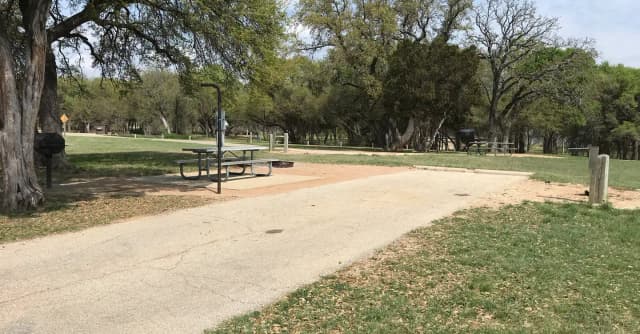 RV site with picnic table, grill, and fire ring