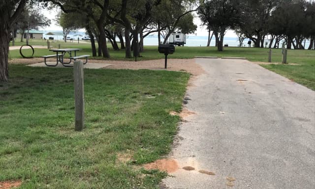 RV site with picnic table, grill, and fire ring