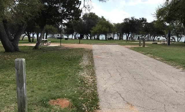 RV site with picnic table, grill, and fire ring