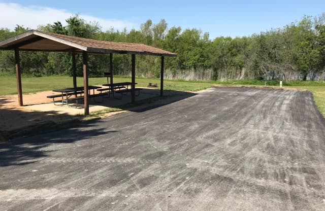 Double RV site with covered picnic tables, grill, and fire ring