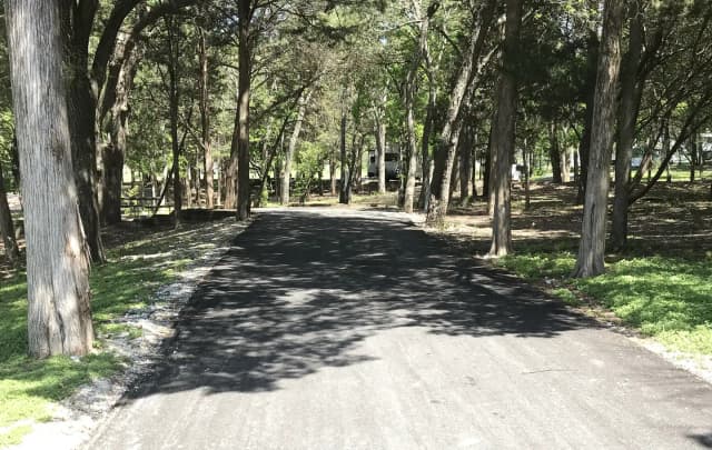 RV site with picnic table, grill, and fire ring