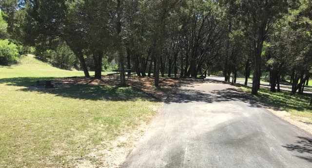 RV site with picnic table, grill, and fire ring