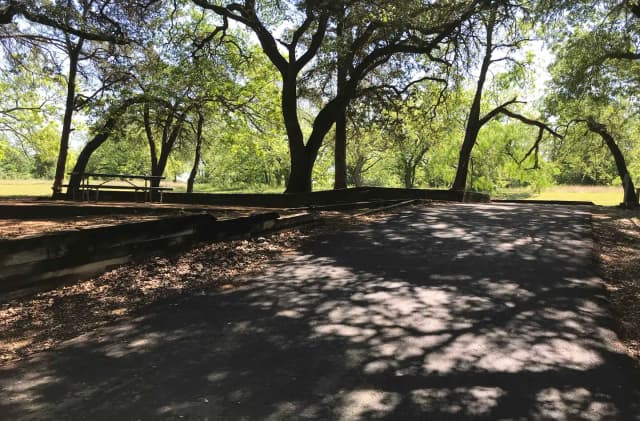 RV site with picnic table, grill, and fire ring