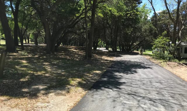 RV site with picnic table, grill, and fire ring