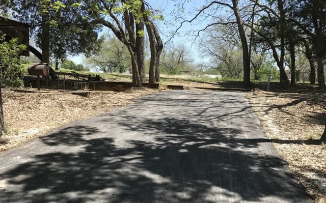 RV site with picnic table, grill, and fire ring