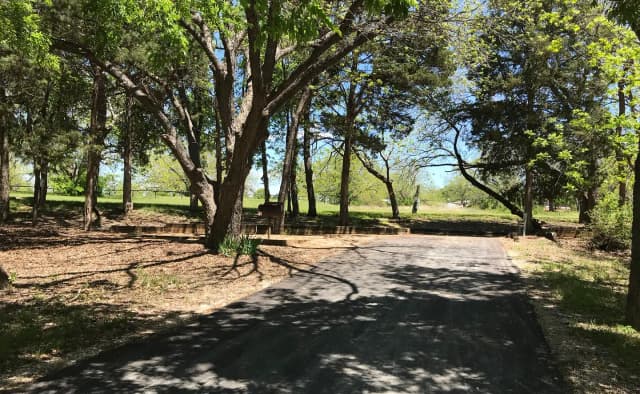 RV site with picnic table, grill, and fire ring