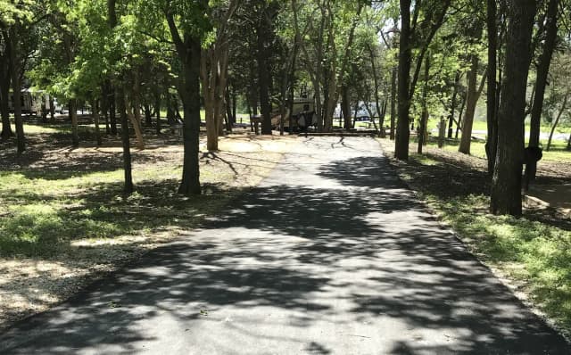 RV site with picnic table, grill, and fire ring