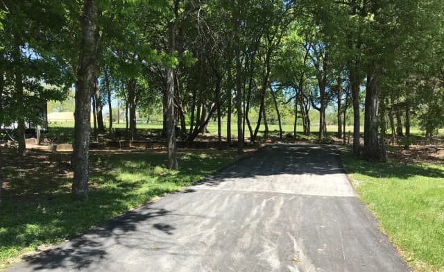 RV site with picnic table, grill, and fire ring