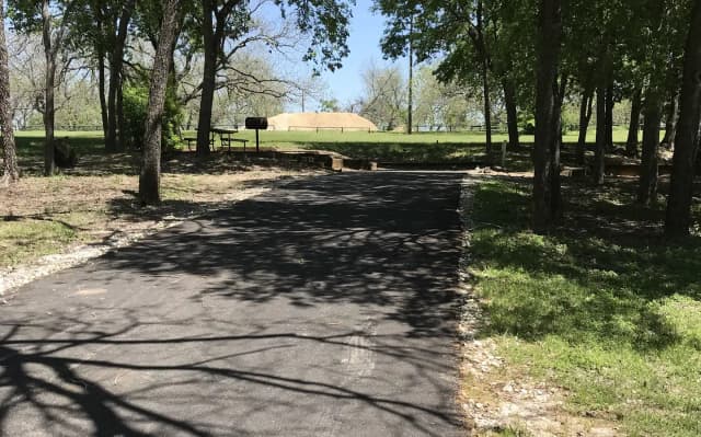 RV site with picnic table, grill, and fire ring
