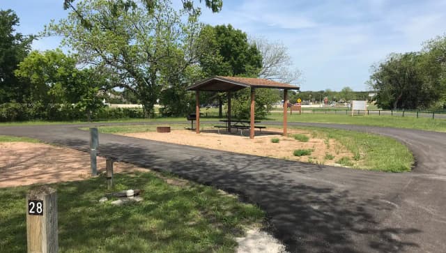 Pull through RV site with covered picnic table, grill, and fire ring