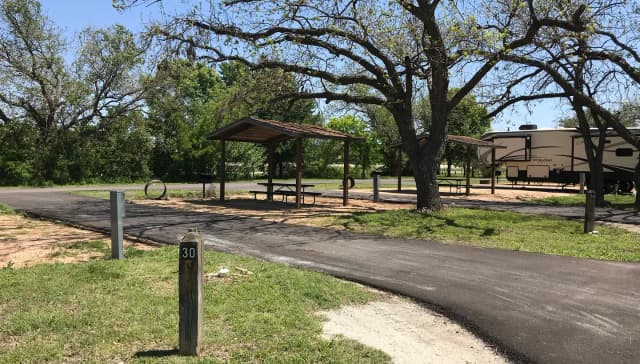 Pull through RV site with covered picnic table, grill, and fire ring