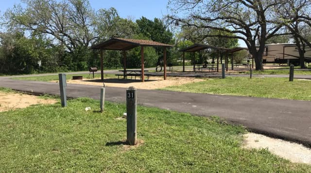Pull through RV site with covered picnic table, grill, and fire ring
