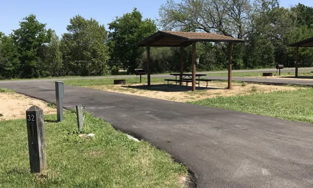 Pull through RV site with covered picnic table, grill, and fire ring