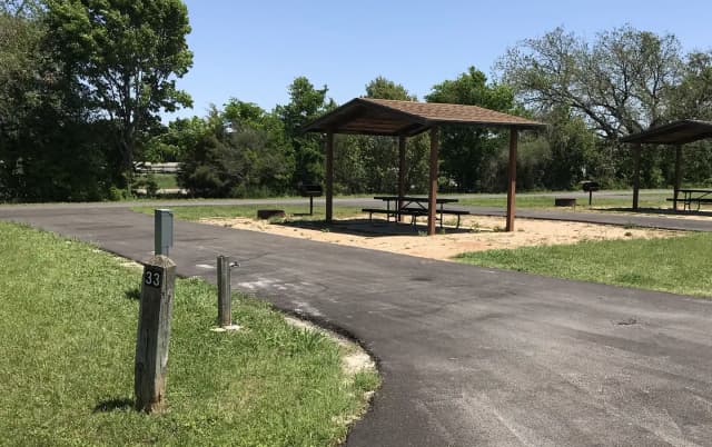 Pull through RV site with covered picnic table, grill, and fire ring