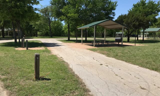 Pull through RV site with covered picnic table, grill, and fire ring