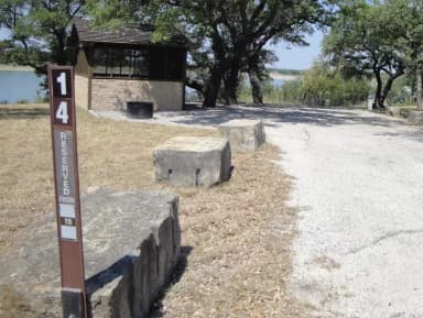 A photo of Site T014 of Loop L1 at LAKESIDE (TX) with Picnic Table, Electricity Hookup, Fire Pit, Shade, Water Hookup, Lean To / Shelter