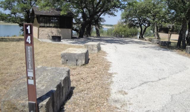 A photo of Site T014 of Loop L1 at LAKESIDE (TX) with Picnic Table, Electricity Hookup, Shade, Waterfront, Water Hookup, Lean To / Shelter