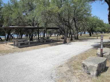 A photo of Site T035 of Loop L1 at LAKESIDE (TX) with Picnic Table, Electricity Hookup, Fire Pit, Shade, Water Hookup