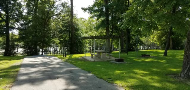 A photo of Site 35 of Loop MAGNOLIA RIDGE  at MAGNOLIA RIDGE with Picnic Table, Electricity Hookup, Fire Pit, Waterfront, Lantern Pole, Water Hookup