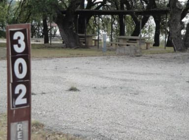 A photo of Site 302 of Loop 3 at FLATROCK (TEXAS) with Picnic Table, Electricity Hookup, Fire Pit, Shade, Water Hookup, Double Site
