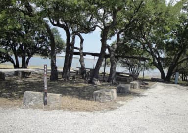 A photo of Site 416 of Loop 4 at FLATROCK (TEXAS) with Picnic Table, Electricity Hookup, Fire Pit, Shade, Water Hookup