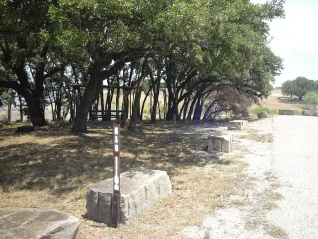 A photo of Site 418 of Loop 4 at FLATROCK (TEXAS) with Picnic Table, Electricity Hookup, Fire Pit, Shade, Water Hookup
