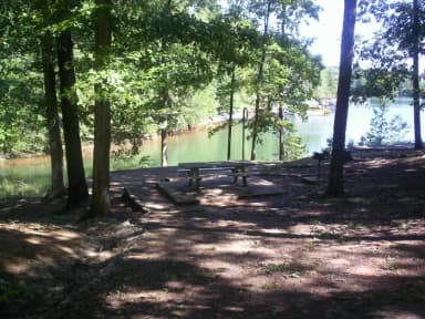 Sloped dirt path down to site, picnic table